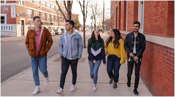 A group of college kids walking and laughing together